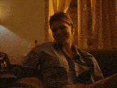 a woman in a suit is sitting on a couch with the words `` whatever suits you babe '' above her .