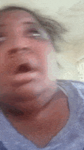 a close up of a woman 's face with her mouth open
