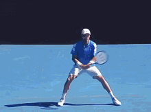 a man is swinging a tennis racket on a blue tennis court .