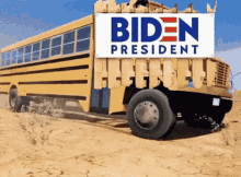 a yellow school bus with a biden president sign on top