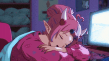 a girl with horns is sleeping in front of a computer monitor