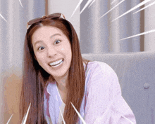 a woman wearing sunglasses and a striped shirt is making a surprised face