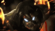 a close up of a monster 's mouth with fire coming out of it in a dark room .