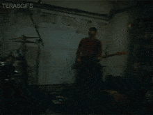 a man playing a guitar in front of a garage door that says terasgifs on the bottom