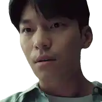 a close up of a man 's face with a white shirt on