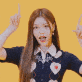 a girl with long hair is wearing a blue vest and white shirt