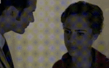 a man and a woman are looking at each other in a blurry picture