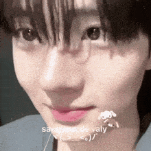 a close up of a person 's face with the words sangwon de valy written in white