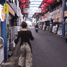 a woman walks down a street with a sign that says 3f on it