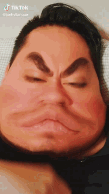 a man is making a funny face with his eyes closed and the caption says tiktok @jonhylianque