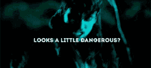 a man in a dark room with the words looks a little dangerous