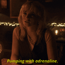 a woman sitting at a table with the words pumping with adrenaline written in yellow