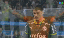 a soccer player wearing an orange jersey that says betsson on it