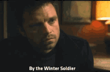 a close up of a man 's face with the words by the winter soldier on the bottom