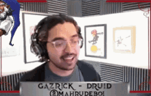 gazrick druid is smiling in front of a sign