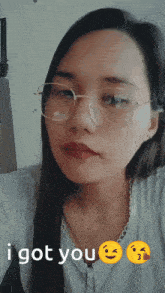 a woman wearing glasses says " i got you " next to a smiley face