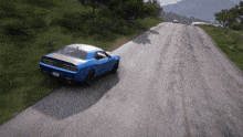 a blue dodge challenger is driving down a mountain road