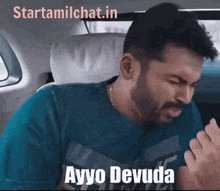 a man with a beard is sitting in the back seat of a car and says ayyo devada