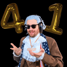 a man wearing a wig and sunglasses stands in front of balloons with the number 41 on them
