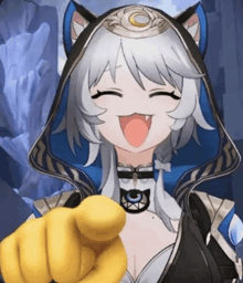 a girl in a cat costume is pointing at the camera and making a funny face .