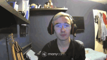 a man wearing headphones and glasses is being recorded on manycam