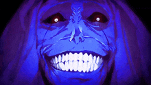 a blue face with red eyes and white teeth is smiling