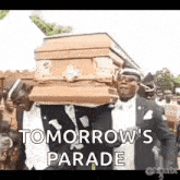 a group of men are carrying a coffin with the words tomorrow 's parade on it .