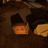 a wooden chest is laying on the ground in a dark area