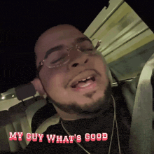 a man with glasses and a beard says " my guy what 's good " in red letters