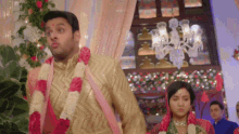 a bride and groom are walking down the aisle at their wedding reception .