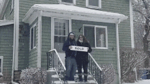excited homeowners sold couple snow