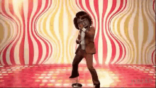 a man in a suit and tie is singing into a microphone .