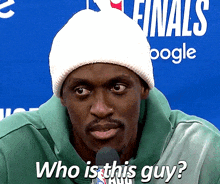 a man wearing a white beanie and a green sweatshirt is asking who is this guy