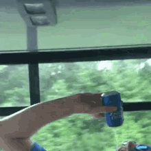 a person is holding a blue can of diet coke
