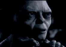 a close up of a person 's face with their eyes closed in a dark room .