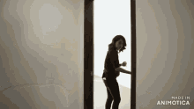 a woman is standing in a doorway with the words made in animatica below her