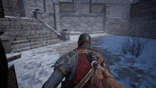 a video game shows a knight in armor walking in the snow