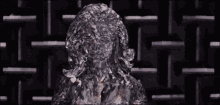 a close up of a woman 's face covered in ice and a maze in the background .