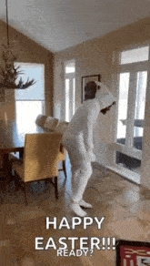 a man in a white bunny suit is dancing in a living room .