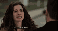 a woman is crying while talking to a man and the words `` it isn 't fair '' are written on the screen .