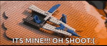 a lego airplane is on a table with the words its mine oh shoot written below it