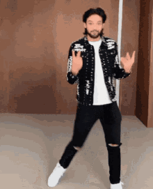 a man wearing a jacket that says ' supreme ' on it is dancing