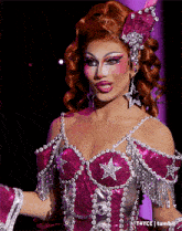 a woman in a pink dress with a star on the front