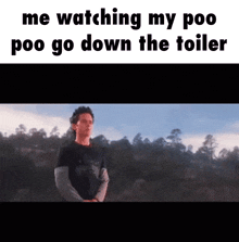 a man in a black shirt is standing in front of a forest while watching his poo go down the toilet .