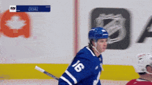 a hockey player with the number 16 on his jersey stands on the ice