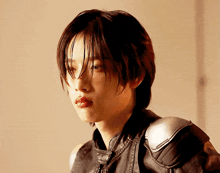 a woman with short hair and a nose ring is wearing a black leather jacket