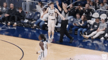 a basketball player with the number 22 on his jersey is jumping in the air on a court .