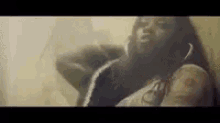 a woman is leaning against a wall in a room in a video .