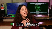 a woman stands in front of a computer screen that says " the stop bits "