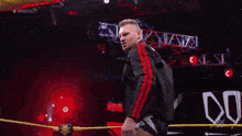 a man in a wrestling ring with the word dominik on his pants
